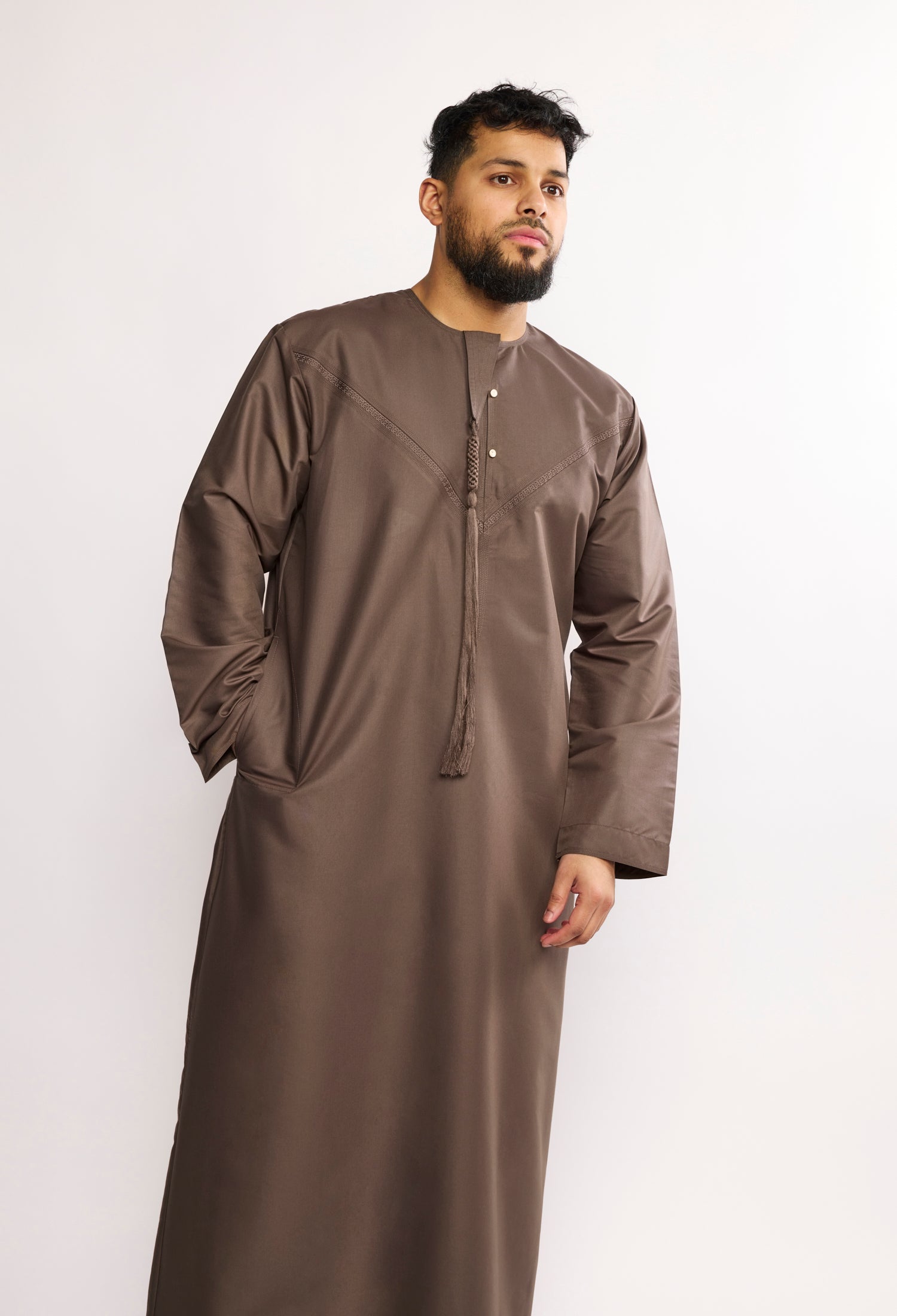 Man wearing a brown long-sleeve garment on a white background
