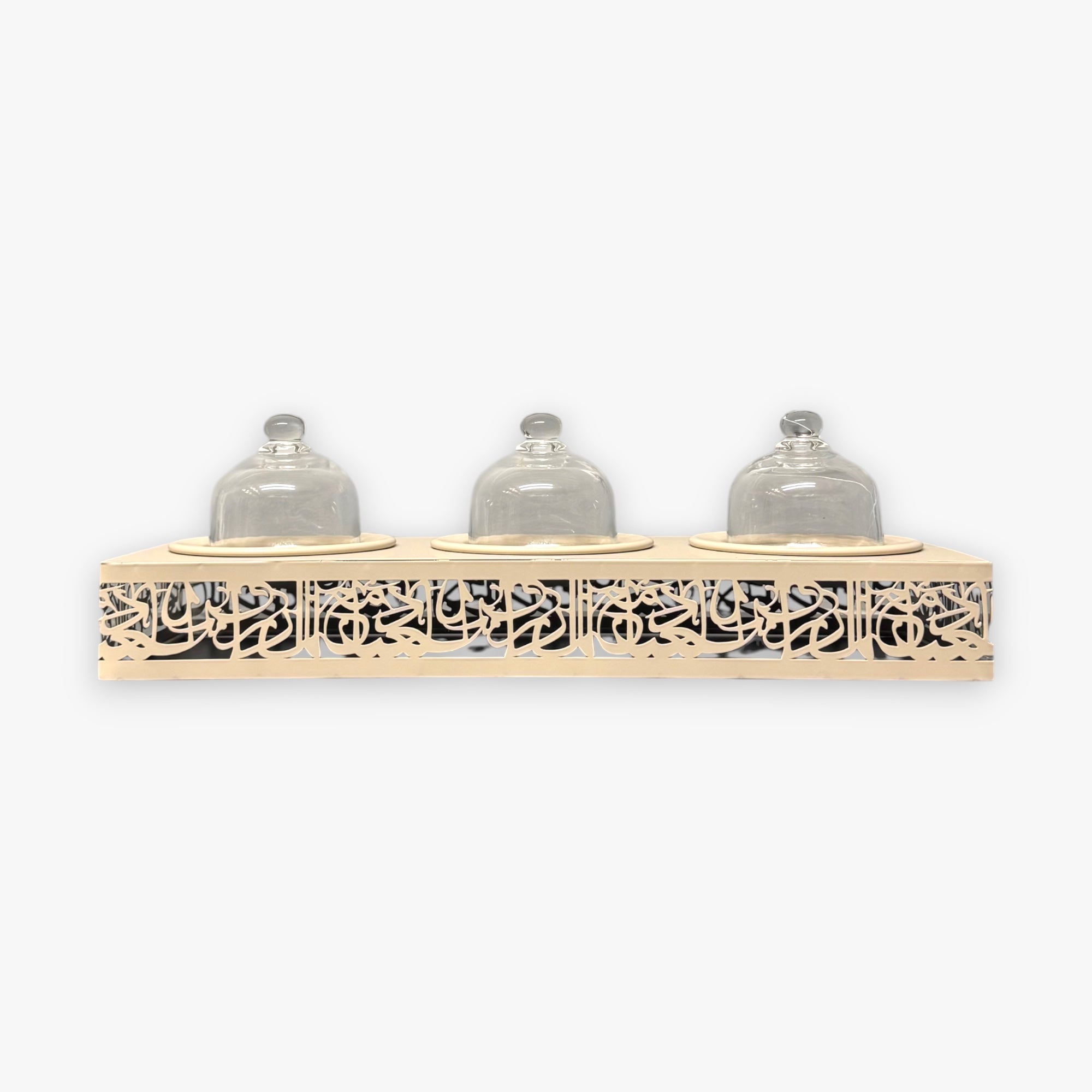 Decorative shelf with three glass jars on a white background