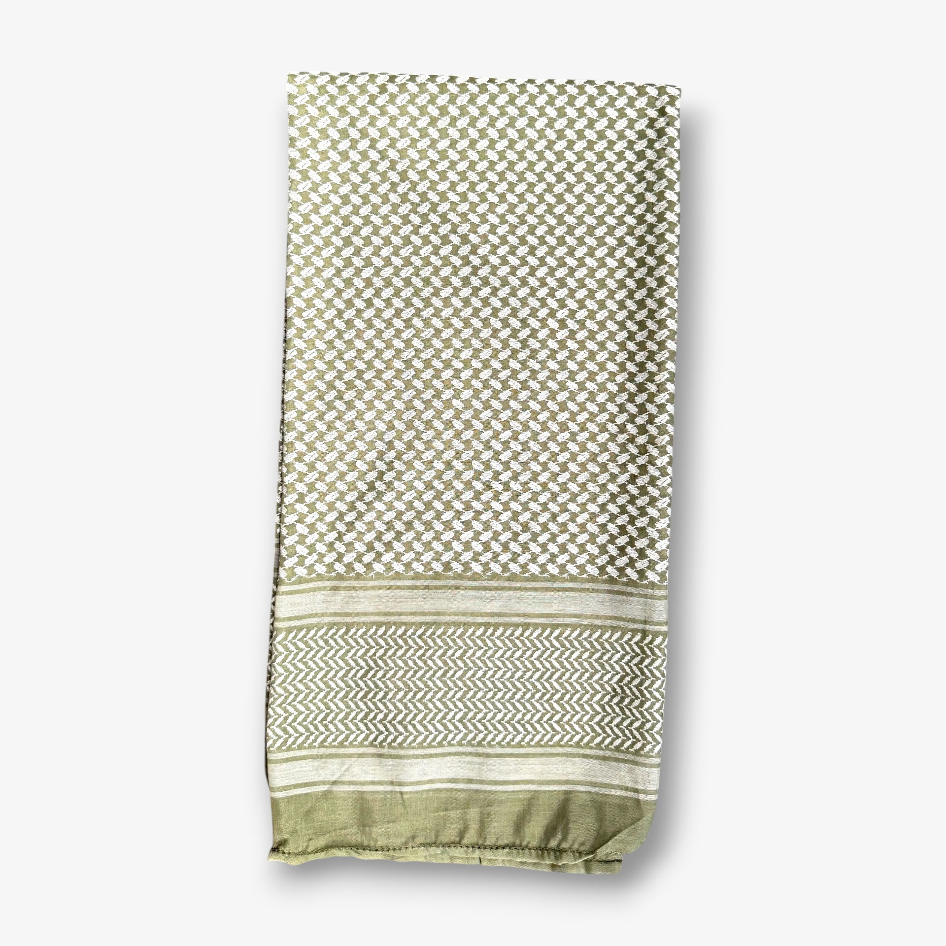 A folded woven textile, likely a scarf, shawl, or throw, featuring a geometric lattice pattern in sage green and cream, with a decorative chevron border and solid trim at the bottom, shown against a light gray background.