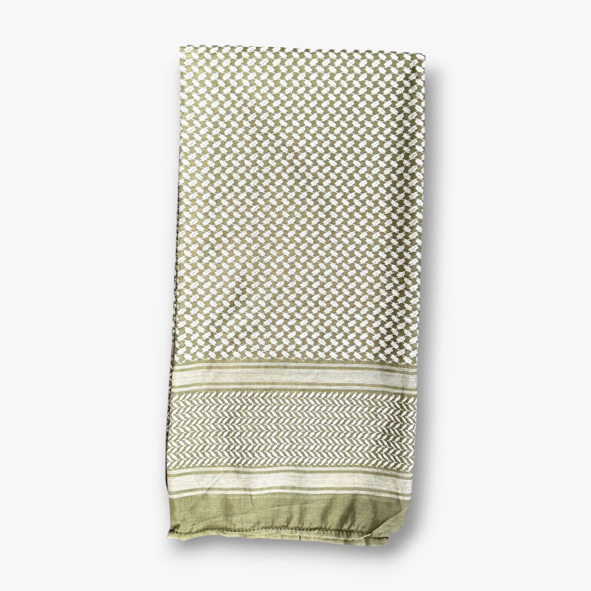 A folded woven textile, likely a scarf, shawl, or throw, featuring a geometric lattice pattern in sage green and cream, with a decorative chevron border and solid trim at the bottom, shown against a light gray background.