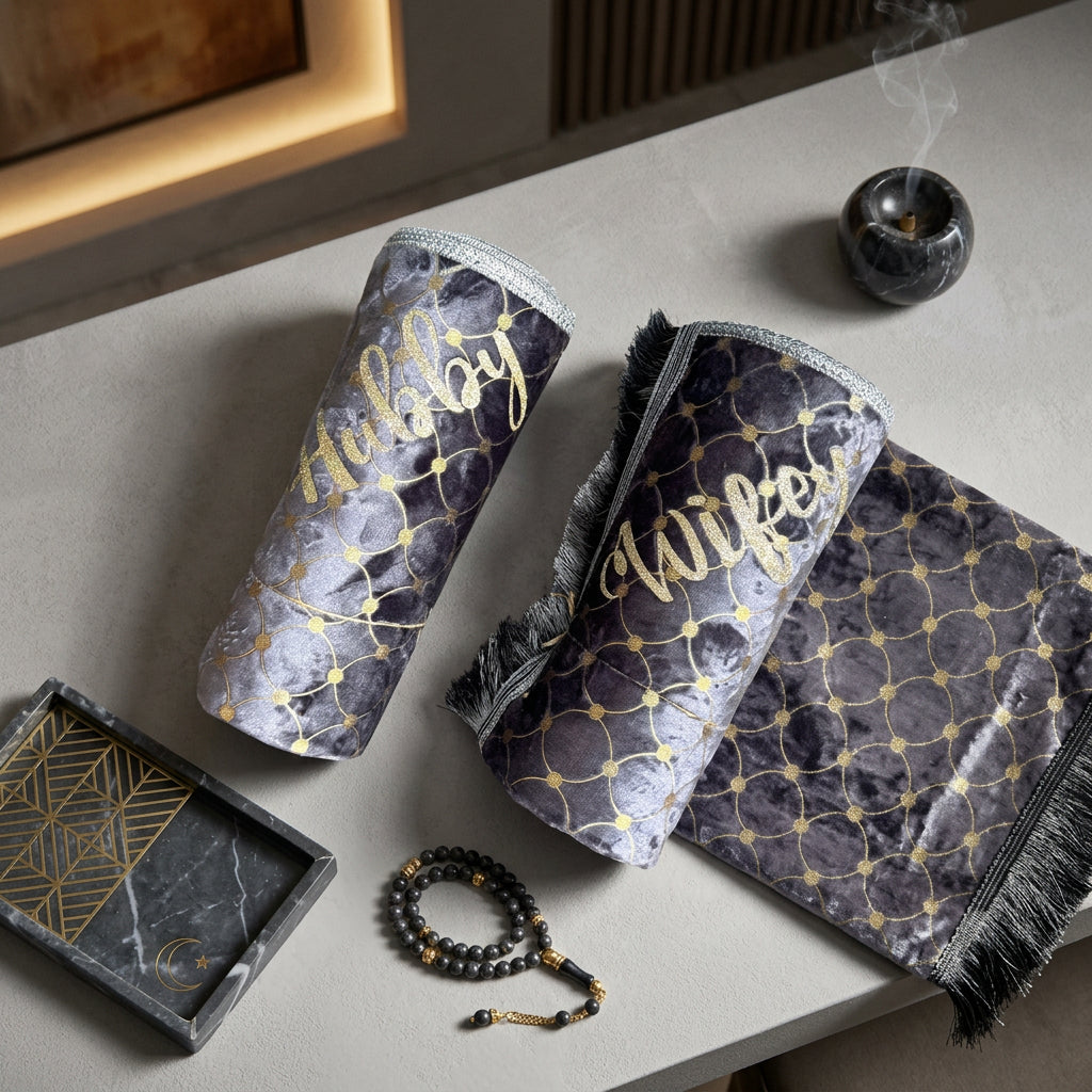 Two foam prayer mats with geometric patterns and the words 'Hubby' and 'Wifey' printed on them in a golden font.