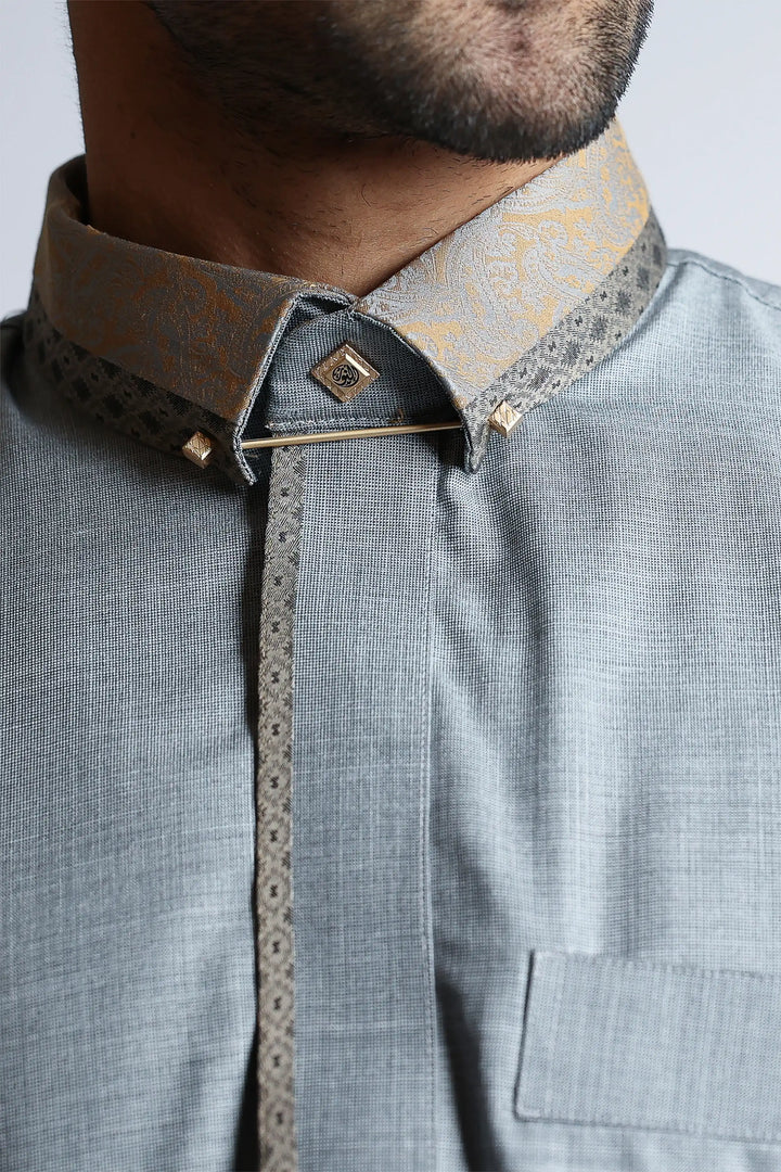 Close-up of a gray shirt with a patterned collar and placket.