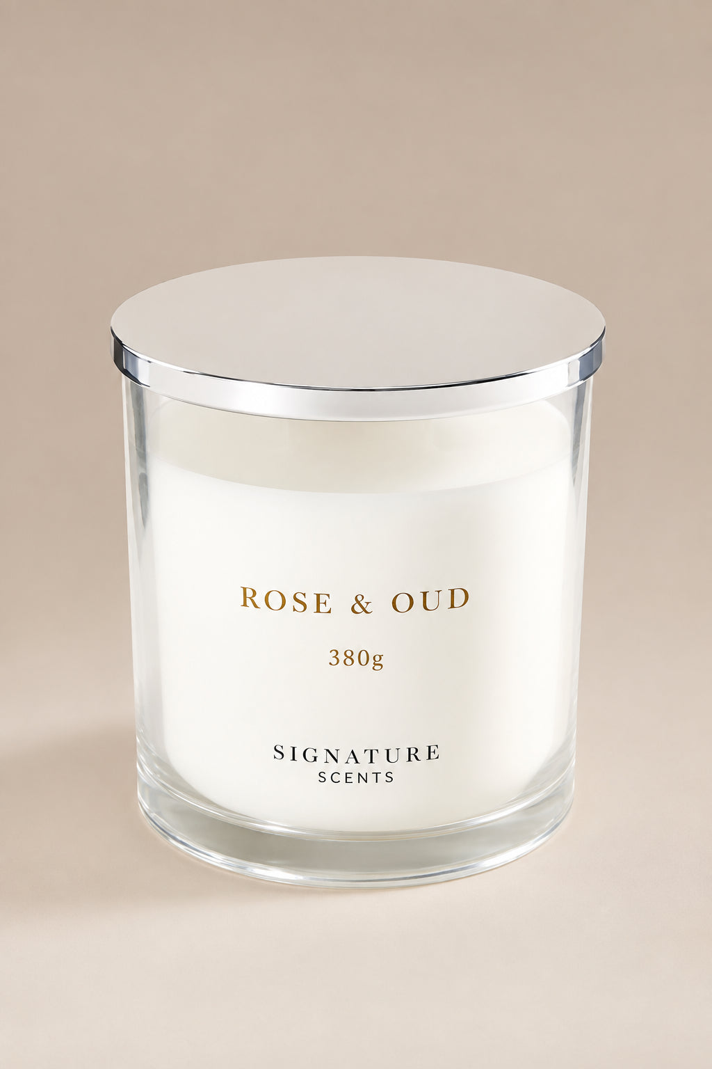 A white scented candle in a clear glass jar with a silver metal lid, labeled 'ROSE & OUD' and 'SIGNATURE SCENTS', set against a solid beige background.