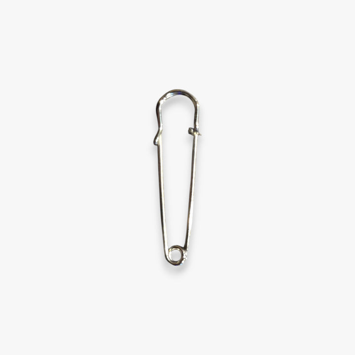 Metal safety pin on a white background
